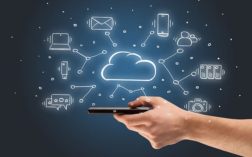 Hand holding a smartphone connected to cloud services, devices and servers